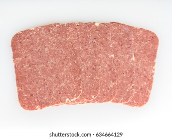 Five Slices Of Corned Beef On A White Background