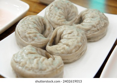 five steamed dumplings(buckwheat dumplings) on a white plate