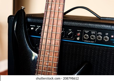 Five String Bass Guitar And Amplifier. Selective Focus