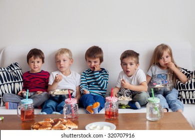 Five Sweet Kids, Friends, Sitting In Living Room At Home, Watching TV And Eating Popcorn