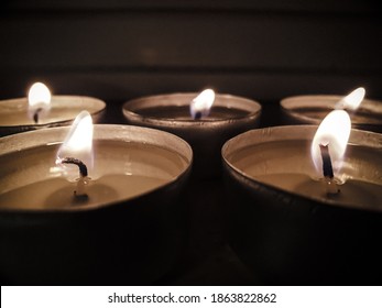 Five tea candles on a window sill