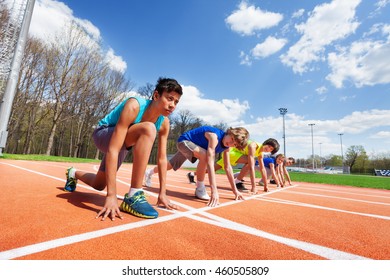 Five Teenage Athletes Ready To Run On A Racetrack