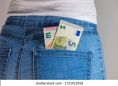 Fünf und zehn Euro in einer Jeans-Tasche. 10 und 5 europäische Euro-Banknoten stecken in einer Jeanentasche fest. 10 und 5 Euro in einer Damenhose Gesenktasche. Geld in Jeans