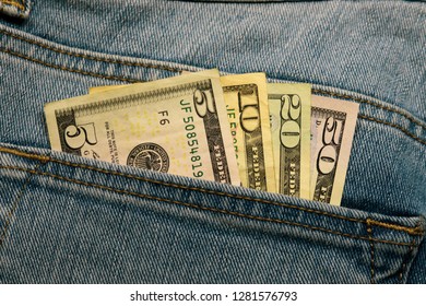 Five, Ten, Twenty, And Fifty Dollar Bill In The Back Pocket Of Blue Denim Jeans