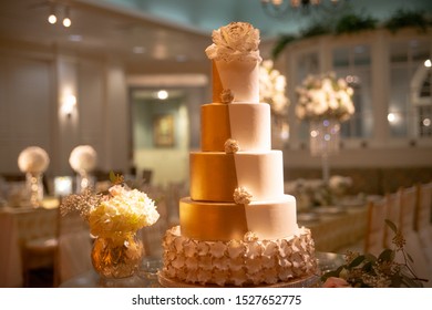 Five tier white and gold tuxedo wedding cake with fondant lace o - Powered by Shutterstock