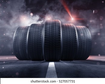 Five tires rolling on a street