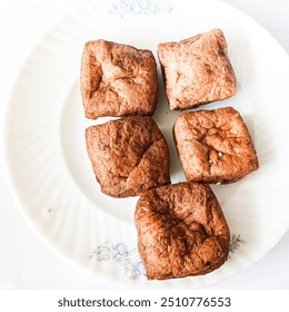 Five tofu pong placed on a white plate. - Powered by Shutterstock