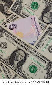Five Turkish Lira between a dollar,vertical image