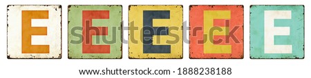 Five vintage tin signs on a white background - Letter E