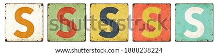 Five vintage tin signs on a white background - Letter S