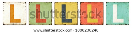 Five vintage tin signs on a white background - Letter L