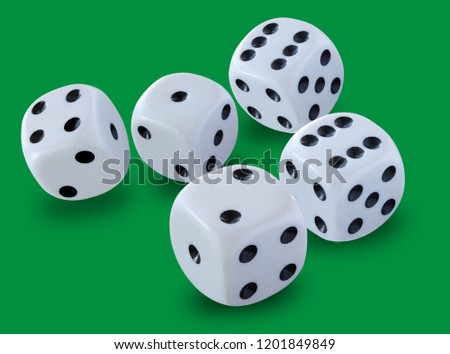 Five white dices size thrown in a craps game, yatzy or any kind of dice game against a green background 
