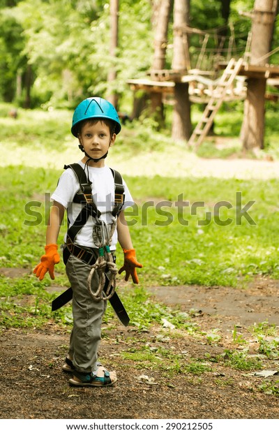 Five year boy on\
rope-way in the forest