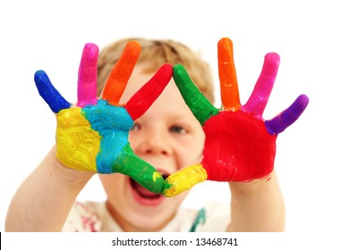 Five year old boy with hands painted in colorful paints ready for hand prints - Powered by Shutterstock