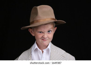 five year old boy playing dress-up makes a cartoon face