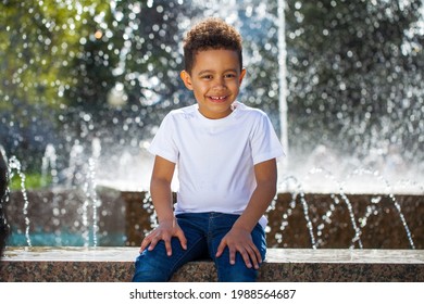 Five Year Old Little Boy In A Summer Park