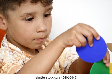 The five years' boy playing with plastic toys