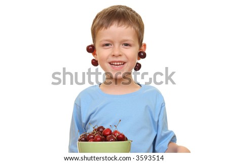 five years old boy and fresh cherries isolated on white