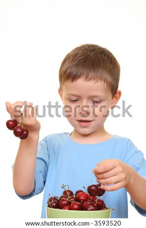 five years old boy and fresh cherries isolated on white