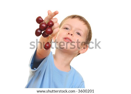 five years old boy and fresh cherries isolated on white
