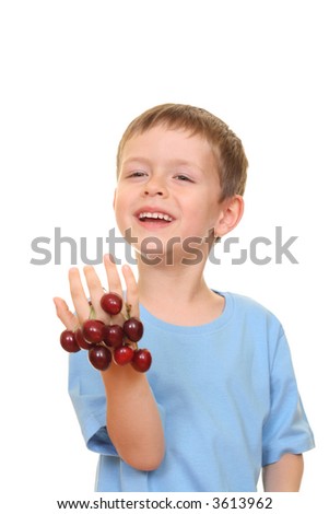 five years old boy and fresh cherries isolated on white