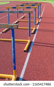 Five yellow and blue athletic obstacles close to each other