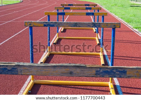 Five yellow and blue athletic obstacles close to each other