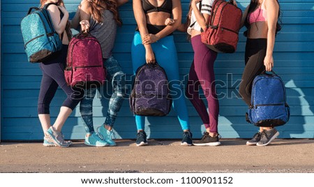 Five Young Girls in Sportswear Holding Backpacks