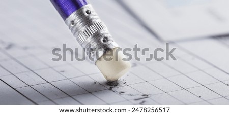 Fix with eraser financial data in document. Concept of banking, financial report and financial audit.