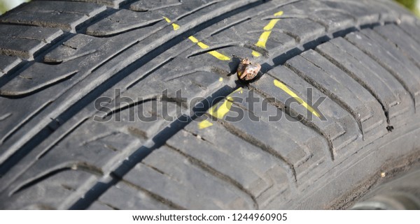 Fix flat car\
tire.  Car tire damage with nail.\
