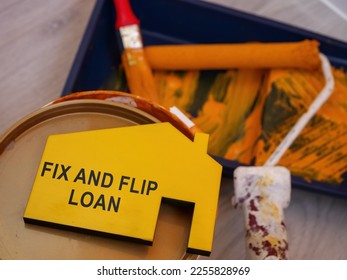 Fix and flip loan inscription, can of paint and brush.