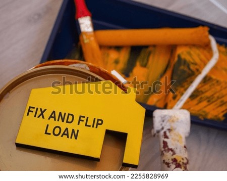 Fix and flip loan inscription, can of paint and brush.