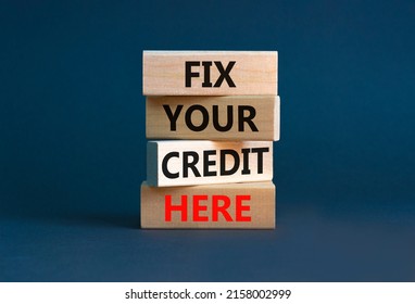 Fix your credit here symbol. Concept words Fix your credit here on wooden blocks on a beautiful grey table grey background. Business, finacial and fix your credit here concept.
