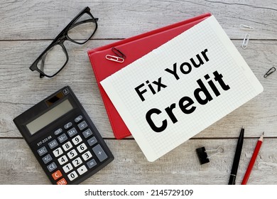 FIX YOUR CREDIT. sheet of paper with text on a red notepad - Shutterstock ID 2145729109