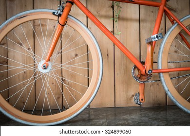 fixed gear bicycle parked with wood wall, close up image part of bicycle - Powered by Shutterstock