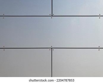 Fixed silver gray rectangular facade panels with joints  