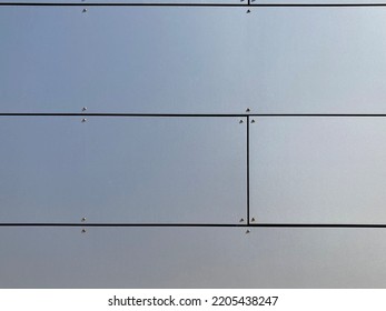 Fixed silver gray rectangular facade panels with joints  