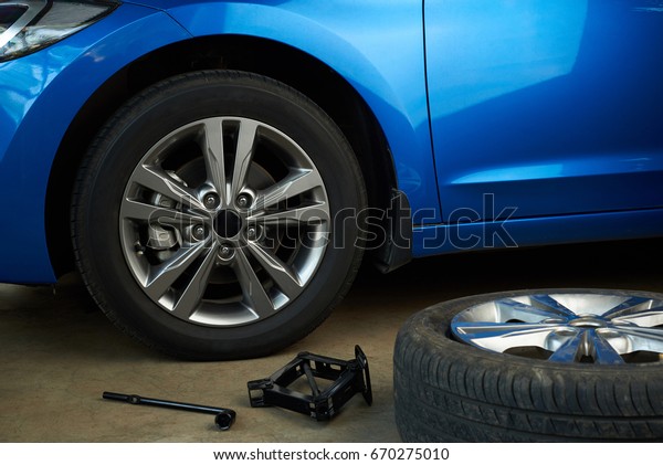 Fixing\
broken car wheel service. Car workshop\
close-up