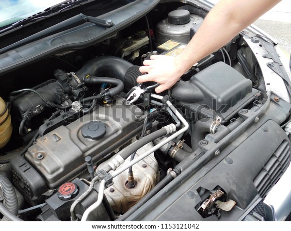 Fixing the car\
engine.