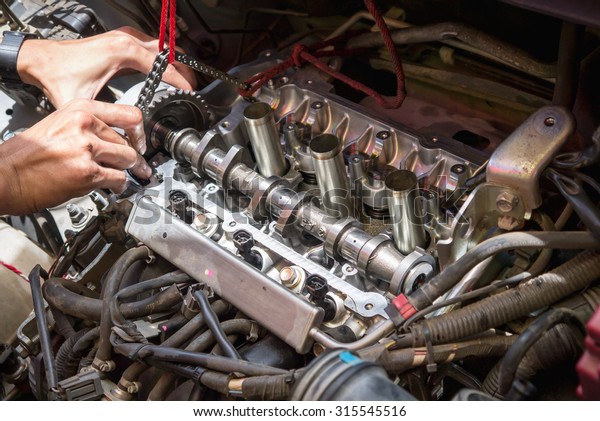 Fixing car engine using local method and\
simply tools found in local part of\
Thailand