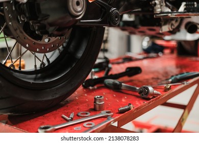 Fixing Custom motorcycle standing in repair shop. Instruments and equipment. Hobbies and unique Jobs - Powered by Shutterstock