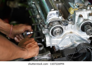 ?Hand fixing on race car's engine - Shutterstock ID 1107226994