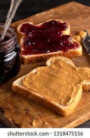 Fixing a Peanut Butter and Jelly Sandwich on a Wooden Kitchen Counter