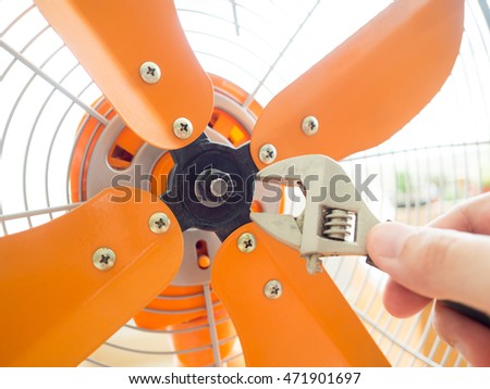Fixing vintage orange fan.