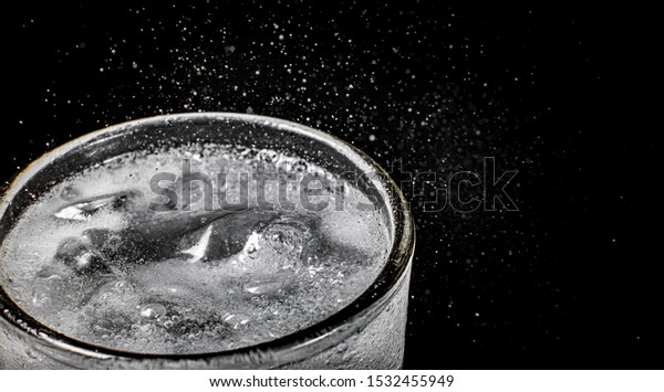 Fizz sparkling\
water Refreshing bubbly Soda Pop with Ice Cubes. Cold soft drink\
carbonated liquid fresh and cool iced drink in a glasses .\
Refreshing and quench thirst concept\
.
