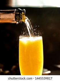 Fizzy Pouring Close Up Of Champagne Mimosa Cocktail