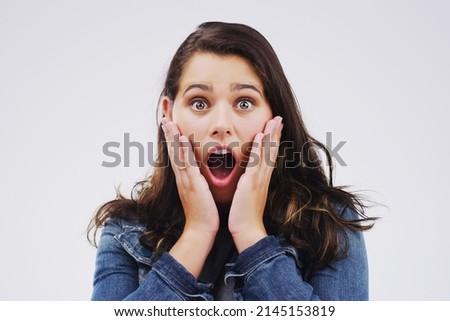 Flabbergasted. Studio portrait of an attractive young woman looking shocked against a grey background. Stock foto © 