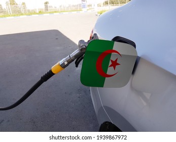 Flag Of Algeria On The Car's Fuel Tank Filler Flap. Petrol Station. Fueling Car At A Gas Station.