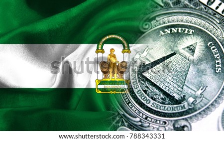 Flag of Andalusia on a fabric with an American dollar close-up.