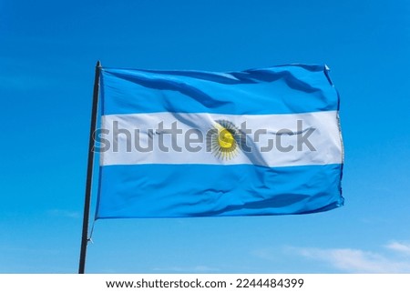 The flag of Argentina, Bandera argentina - Bandera Nacional, is a horizontal triband of light blue (top and bottom) and white with the Sun of May centered)